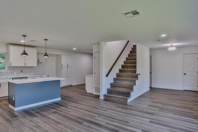 Kitchen featuring hanging light fixtures, a kitche
