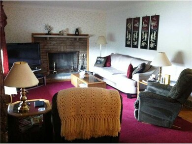 Living Room. Stone fireplace and harwood under rug