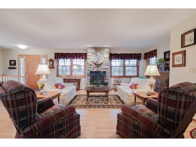 Lovely living room features many gridded windows &