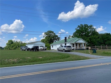 View of front of house with a front lawn, fence, c