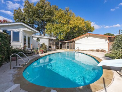 Pool with view of guest house and screened patio