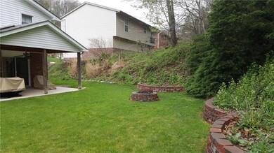 Exterior rear showing patio and brick planters wit