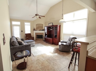Living room featuring high vaulted ceiling, a tile