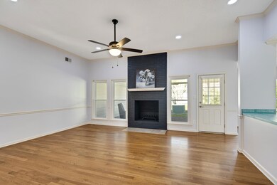 Living room with ceiling fan, wood flooring, a fir
