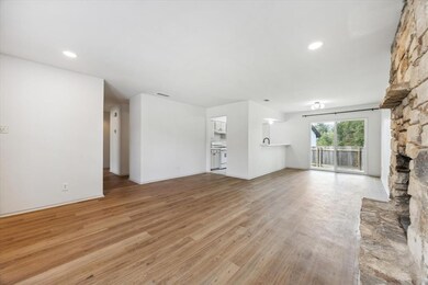 Unfurnished living room with light wood-type floo