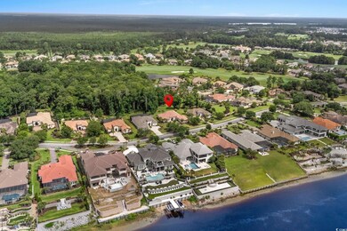 Aerial view of property and surrounding area featuring nearby suburban area