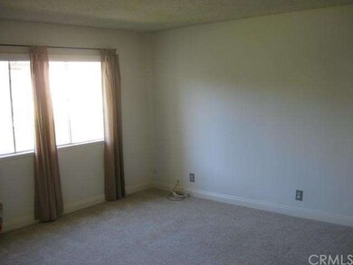 Living room with curtains and natural lighting.  