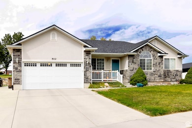 Single story home featuring stone siding, a porch, stucco siding, and driveway