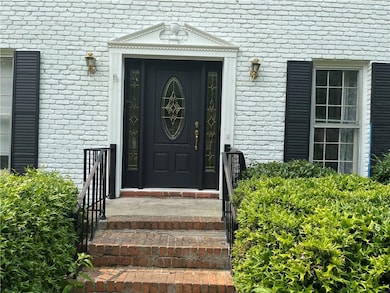 Entrance to property featuring brick siding