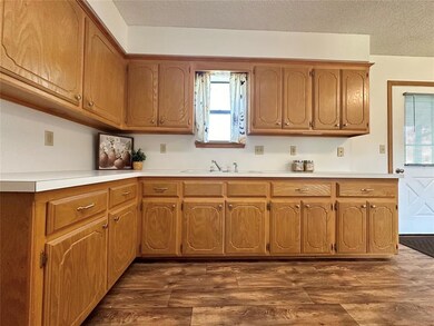 Kitchen with dark hardwood / wood-style floors, a 