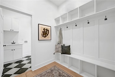 Mudroom with baseboards and light wood finished floors
