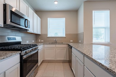 Kitchen featuring appliances with stainless steel