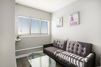 Living area with wood finished floors and baseboards