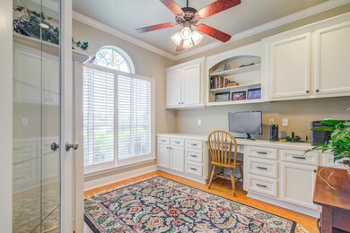 Spacious study with built-in desk and cabinets
