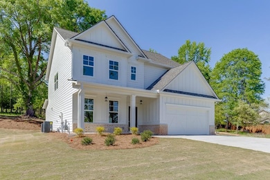 View of front of house with concrete driveway, cen
