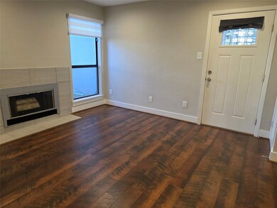 Unfurnished living room featuring baseboards, woo