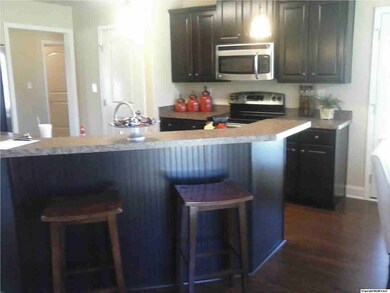 RAISED KITCHEN BAR OPEN TO FAMILY ROOM