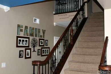 Gorgeous iron stair rail with dark stained handrai