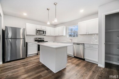 The kitchen includes a center island with extended