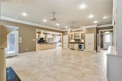 Another view of the den, wet bar, ice maker/wine c