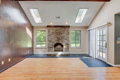Unfurnished living room featuring lofted ceiling w