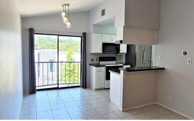 Kitchen featuring range with electric stovetop, f