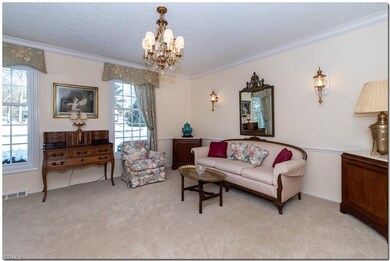 Formal living room with sconces and freshly painte