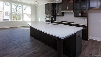 Spacious gourmet kitchen with large arched island 