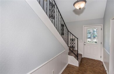 front door and stairs leading to the three upstair
