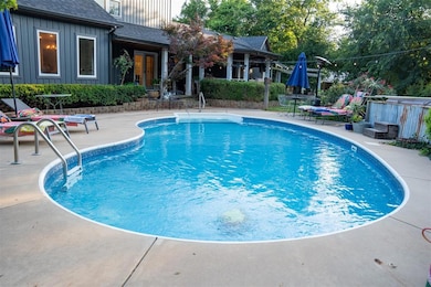 View of pool featuring a patio and a jacuzzi