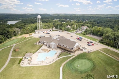 Bird's eye view of a pool and a heavily wooded area