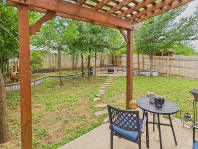 Fenced backyard with a patio and a pergola