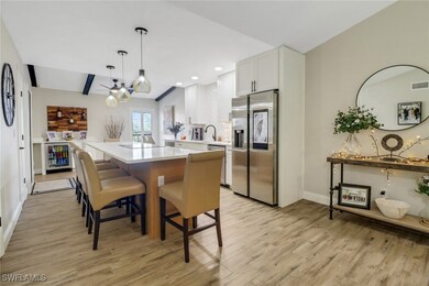 Kitchen featuring a kitchen island, appliances wit