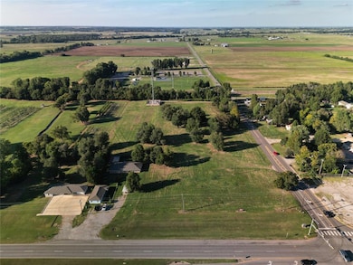 Aerial view of property and surrounding area featuring rural landscape