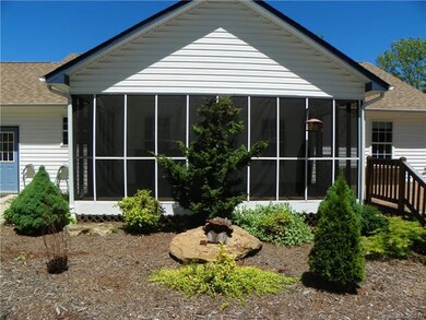 Screened porch, wrap around deck, extensive landsc