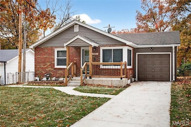 View of front of property with brick siding, a garage, and driveway