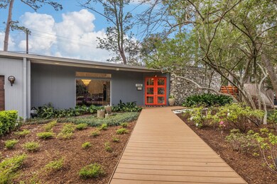 Lush landscaping and tranquil fountain adorn the e