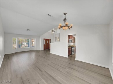 Unfurnished living room featuring a chandelier, va