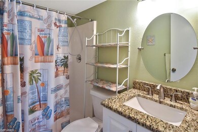 Bathroom with vanity, curtained shower, and toilet