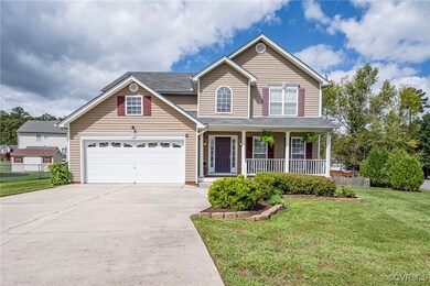 View of front of home with a front yard and covere