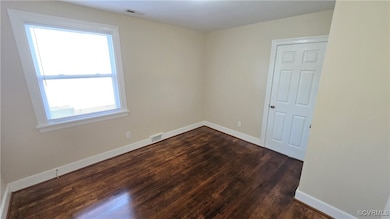 Unfurnished room with dark wood finished floors an