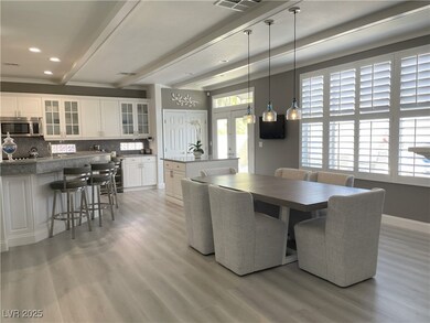 Dining space with beamed ceiling, light wood-style floors, and french doors