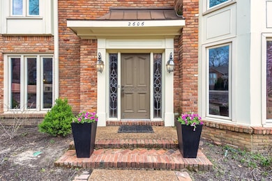 Property entrance featuring brick siding