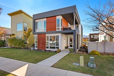 Contemporary house featuring a balcony and stucco siding