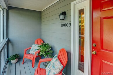 A gracious front porch with seating for two.