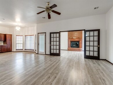 Unfurnished living room featuring a fireplace, lig