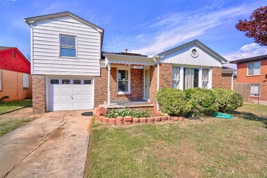 Tri-level home with a front lawn and a garage