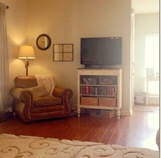 Another view of  the spacious living room with lam