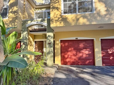 Property entrance with stucco siding and an attached garage