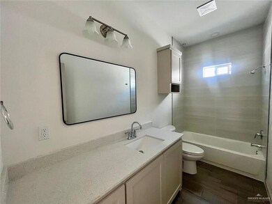 Full bath featuring vanity, shower / bath combination, and wood finished floors